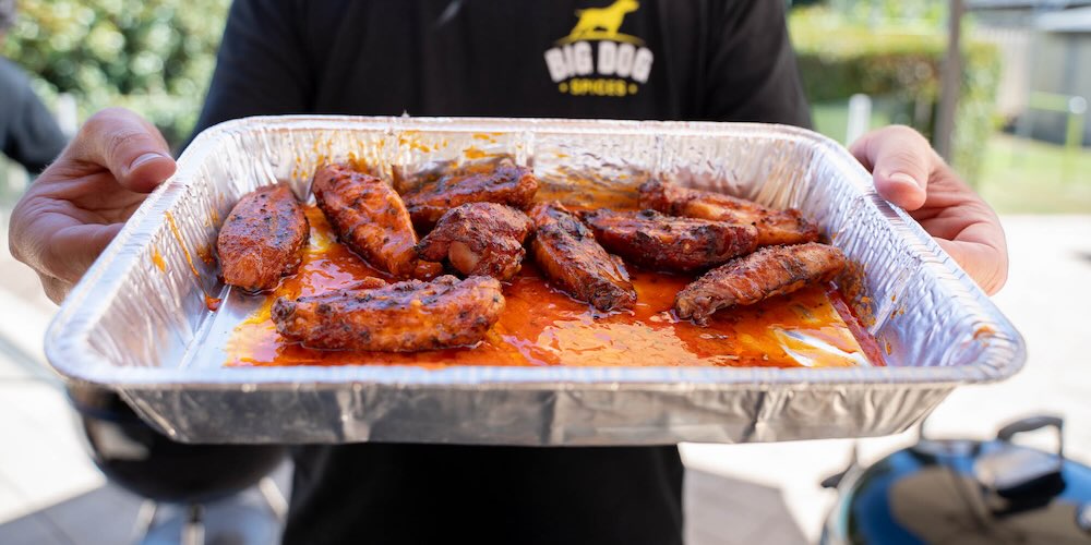 Brad holding chicken wings with the best spices for chicken on them